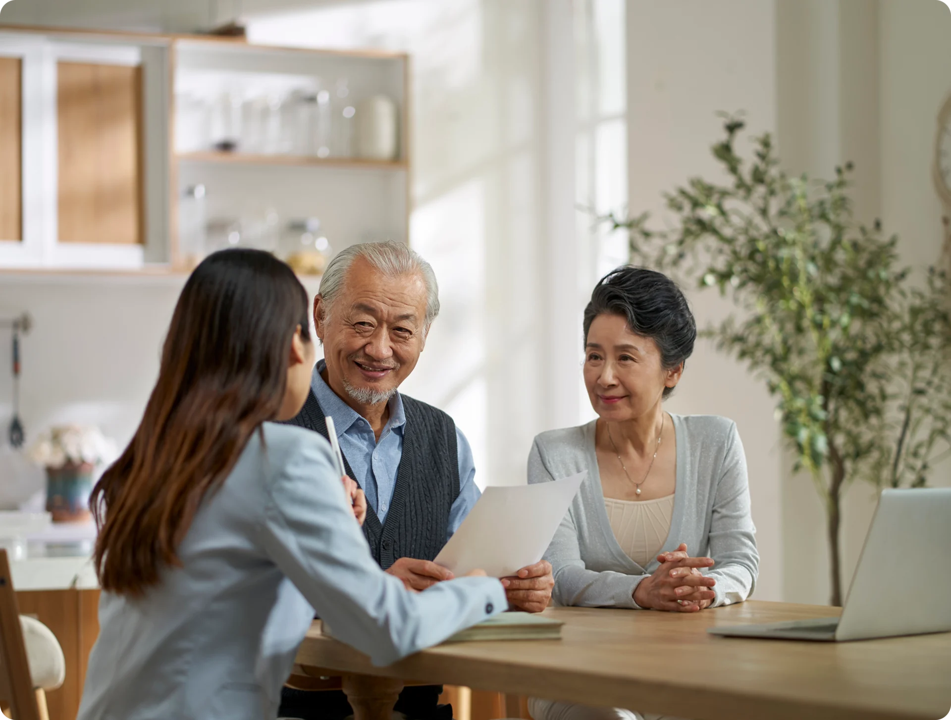 Elderly couple meeting with financial advisor.