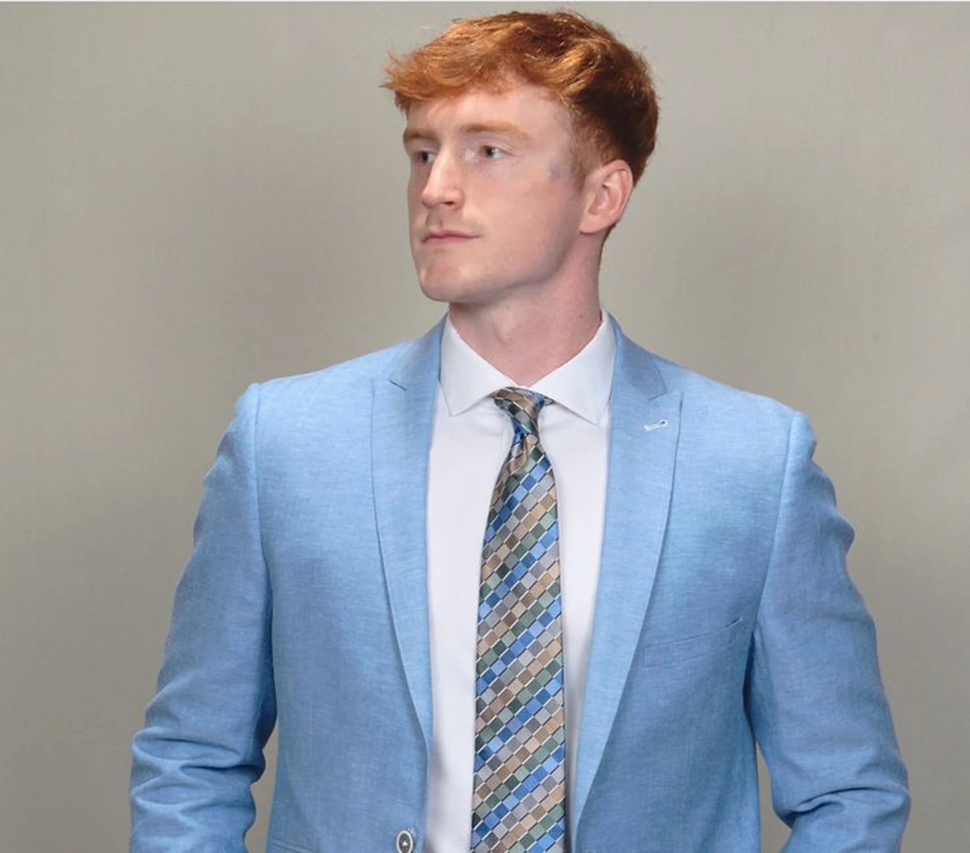 Man in blue suit, patterned tie.